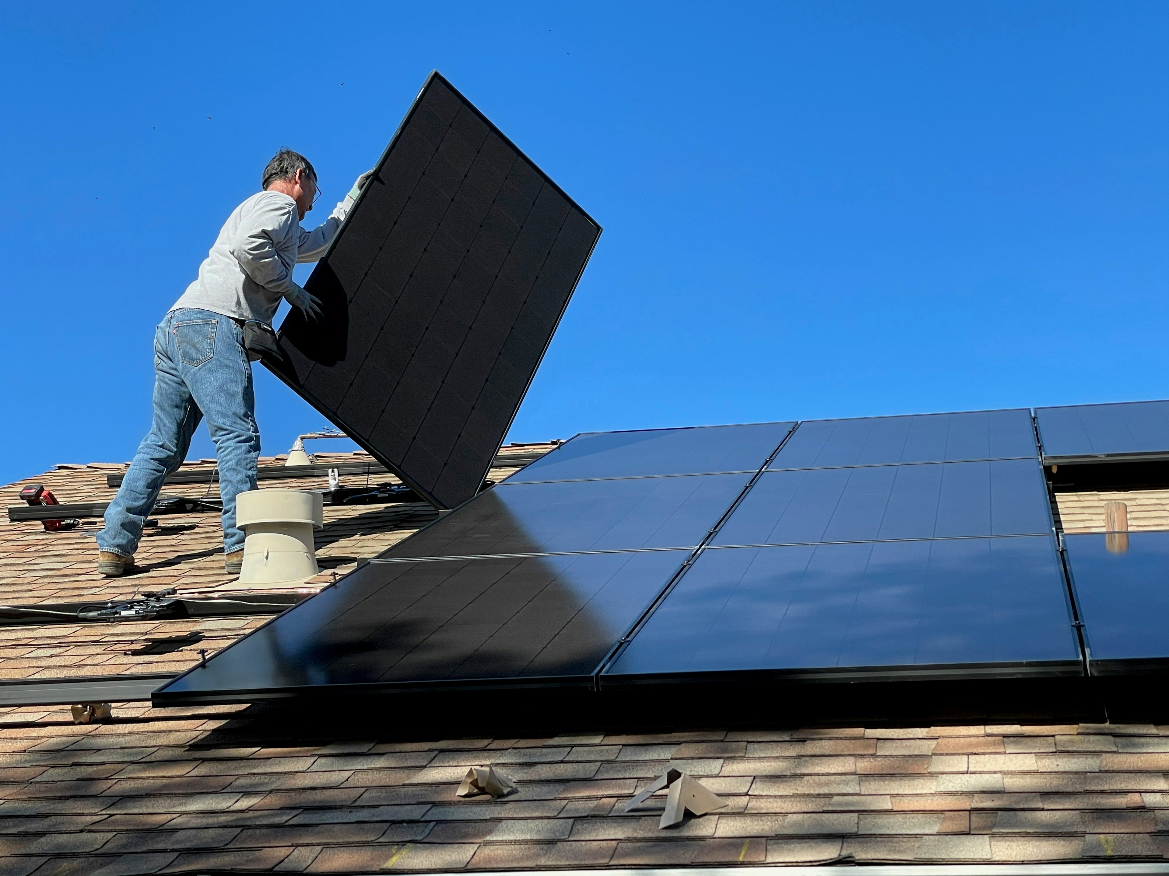 Solar panels on a Mediterranean house roof with ocean view